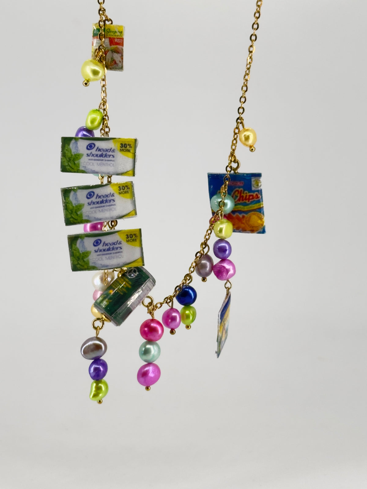Sari Sari Essentials Shampoo, Ligo Sardines, Birch Tree, Sinigang Mix, and Mr. Chips Chain Necklace